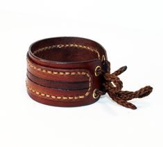 Adjustable Hand-stitched Cuff Bracelet, Leather Wristband For Everyday Use, Adjustable Hand Tooled Leather Bracelet, Adjustable Leather Cuff Bracelet With Waxed Finish, Leather Bracelet With Wrist Strap For Everyday Use, Hand Tooled Brown Leather Bracelets, Hand Tooled Leather Cuff Bracelet, Hand-tooled Leather Cuff Bracelet, Brown Leather Hand-tooled Bracelets