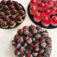 two plates filled with strawberries, chocolate covered strawberries and desserts next to each other