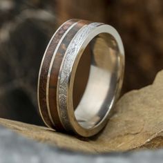 When it comes to wedding bands many begin to look the same. However, my rings go beyond the ordinary and boast a one of a kind nature. This wedding band holds a trio of inlays that are truly unmatched, meteorite, petrified wood, and dinosaur bone. Each element has its own unique pattern and origin. Get something special to signify your loving and commitment. RING LAYOUTRing Width: 8 mmRing Sleeve: TitaniumRing Profile: Round or FlatRing Finish: Polished 0.5 mm Titanium2 mm Gibeon Meteorite0.5 mm Commitment Ring, Flat Jewelry, Dinosaur Ring, Dinosaur Bone Ring, Gibeon Meteorite, Meteorite Jewelry, Unique Wedding Band, Bone Ring, Protection Jewelry