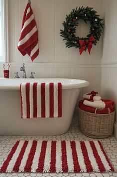 a white bath tub sitting next to a christmas wreath