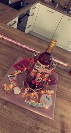 a bottle of wine sitting on top of a table next to other bottles and confetti