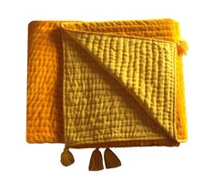 a yellow blanket with tassels hanging from it's sides on a white background