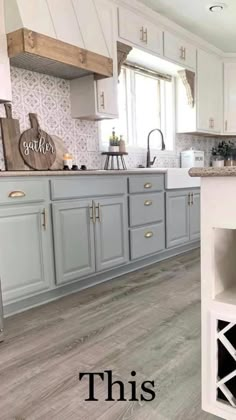 a kitchen with gray cabinets and white counter tops