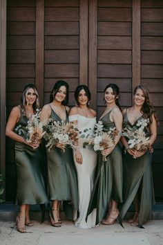 the bridesmaids are all wearing green dresses and holding bouquets in their hands