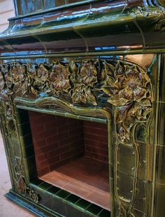 an ornate fireplace with green and gold paint