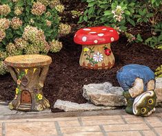 two garden stools sitting next to each other in front of some flowers and plants