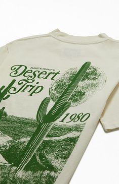 Embody the tranquility of desert life with PacSun's Pacific Sunwear Desert Trip T-Shirt. This tee is complete with short sleeves, graphics on the front and back, a crew neckline, PacSun branding, and a classic construction to complete the look.    	Solid color tee 	Short sleeves 	Crew neckline 	Classic construction 	Front and back graphics 	PacSun branding Clever Graphic Tees, Graphic Tees Pacsun, Camp Graphic Tee, Florida Graphic Tee, Camp Shirts Design, Desert Shirt Design, Vintage Camp Shirts, Vintage Tshirts Designs, Front And Back Shirt Design