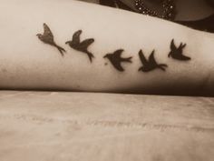 a woman's arm with birds on it and the word love written in black ink