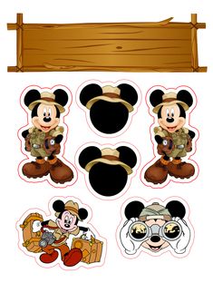 mickey mouse cutouts are shown in front of a wooden sign and some other items