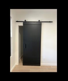 an empty room with a black sliding door