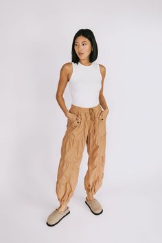 Take your adventures to the next level with the FREE PEOPLE Set Me Free Pant! This durable, water-resistant nylon pant is stacked with style: the shirred panels with elasticated cuffs keep your look fly and your adventures bold! Time to let your wild side out. Ready…set…go! Details Relaxed fit Wide leg Mid rise Ankle length Water resistant Elastic waistband with adjustable drawstring Elastic cuffs Sizing Approximate measurements: SIZE LENGTH WAIST INSEAM X Small 38” 26” 28” Small 38” 28” 28” Fab Nylon Parachute Pants With Drawstring For Outdoor, Nylon Parachute Pants With Drawstring For Outdoor Activities, Summer Nylon Cargo Pants For Hiking, Nylon Parachute Pants With Drawstring For Hiking, Nylon Cargo Pants For Summer Hiking, Functional Nylon Parachute Pants With Elastic Waistband, Sporty Parachute Pants For Hiking In Spring, Spring Nylon Cargo Pants For Hiking, Utility Parachute Pants With Elastic Waistband For Hiking