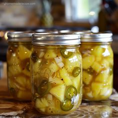 three mason jars filled with pickles and onions