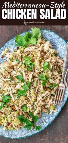 a blue plate topped with chicken salad and garnished with cilantro leaves