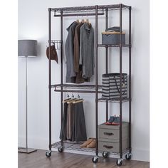 an iron rack with clothes and shoes on it in a room next to a lamp