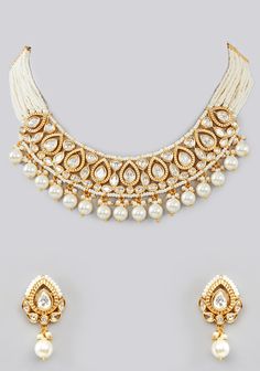 Featuring a Kundan Gold Pearl Necklace Set studded with Kundan stones adorned with faux diamonds in a tear drop pattern, set in mixed metal with gold plating. It is paired with a matching pair of earrings. Perfect for wedding and festive occasions. Composition : Mixed Metal Care: Avoid exposure to water and perfume. Store in dry plastic or fabric pouch. To clean, use a soft cloth to wipe the jewellery. Delivery : 6-8 weeks as the product is hand crafted. For more information and sizes please contact fabiliciousfashion@gmail.com or visit our Copenhagen studio. About the Designer : If you're a bride-to-be or simply someone who loves exquisite jewellery, then Zevar by Geeta is the brand for you! Geeta Sangra is a master at blending traditional Indian themes with modern fashion trends, resulti Gold Teardrop Jewelry Sets For Celebration, White Jeweled Kundan Necklace For Festivals, Gold Bridal Necklace With Gota Work For Reception, Teardrop Jewelry With Intricate Design For Party, Teardrop Party Jewelry With Intricate Design, White Jeweled Kundan Necklace, White Jeweled Bollywood Jewelry, Gold Teardrop Bridal Necklace With Pearl Drop, Elegant Teardrop Bridal Necklace For Festive Occasions