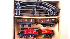 a box filled with different types of toy trains