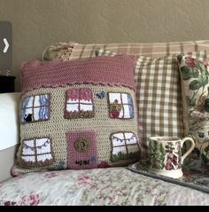 the pink rose fairy pillow is next to a coffee cup and mug on a bed