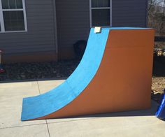 a blue and orange ramp in front of a house