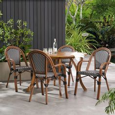 an outdoor table and chairs with blue cushions