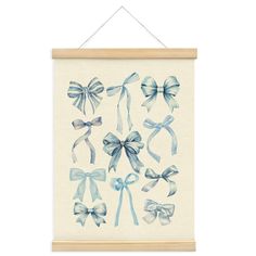 a white framed wall hanging with blue bows on it's front and back sides