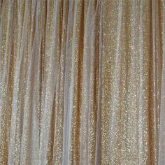 gold sequin curtains are hanging on the wall