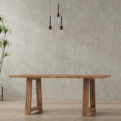 a wooden table sitting next to a potted plant on top of a tiled floor