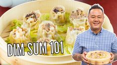 a man holding a bowl filled with dumplings next to the words dim sum 101