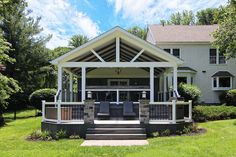 a large house with a covered porch in the front yard