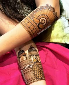 a woman's arm with henna tattoos on it