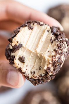 a hand holding a cookie with peanut butter on it and the word pinterest written in red