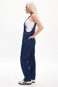 Vintage-inspired Dickies overall in a heavyweight denim with a touch of stretch. Designed in a relaxed fit and features a reinforced double-front panels, buckle closure adjustable straps and utility pocket detailing throughout. Features Dickies double-front bib overalls Denim coverall Heavyweight stretch denim Reinforced double front panels and buckle straps Front bib pocket 11 pockets including zip bib pocket, hidden back pocket and 3 tool pockets Straight leg Relaxed fit Full length Button closures Content + Care 67% Cotton, 28% polyester, 3% viscose Machine wash Imported Size + Fit Model in Indigo is 5’8.5" and wearing size Small Measurements taken from size Small Waist: 40" Inseam: 31" Leg opening: 17" | Dickies Double-Front Bib Overalls in Indigo, Women's at Urban Outfitters Fitted Dark Wash Utility Overalls, Utility Overalls With Button Closure, Dark Wash Straight Leg Overalls For Work, Utility Bib Front Bottoms In Dark Wash, Utility Denim Overalls With Belt Loops, Dark Wash Utility Denim Jumpsuit With Bib Front, Utility Style Dark Wash Denim Jumpsuit With Bib Front, Denim Blue Utility Overalls With Bib Front, Denim Bib Front Jeans For Workwear