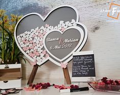 a table topped with lots of flowers next to a chalkboard and wooden easel