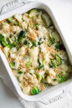 a casserole dish with broccoli, cauliflower and cheese