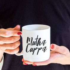 a woman holding a coffee mug with the words nutha cuppa printed on it