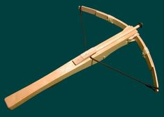 a wooden bow and arrow set on a green backgroung with black handles