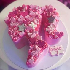 a pink cake decorated with hearts and crosses