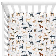 a white crib with dogs on it and the letter d in orange, brown, blue, and black