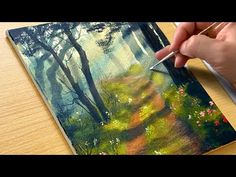 someone is painting a forest scene with acrylic paint