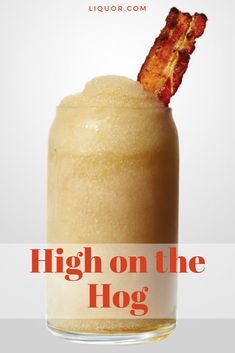 bacon sticking out of the top of a glass with liquid in it that says high on the hog