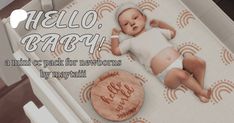 a baby is laying on the floor next to a wooden sign that says hello baby