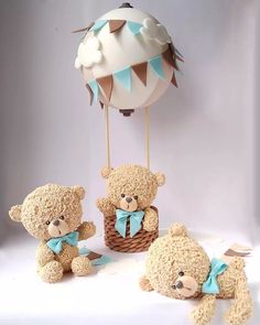 three teddy bears sitting in front of a hot air balloon