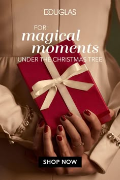 a woman's hands holding a red gift box with white ribbon and the words, for