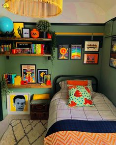 a bed room with a neatly made bed and lots of pictures on the wall above it