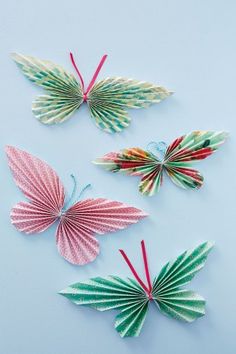 three paper butterflies on a blue background with color swatches for the bottom and bottom