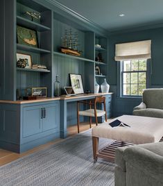 a living room filled with furniture and bookshelves on top of blue shelves next to a window