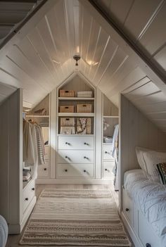 an attic bedroom with built in closets and white bedding, carpeted flooring