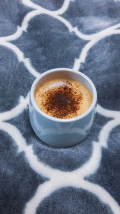 there is a cup of coffee on the floor with brown stuff in it's center