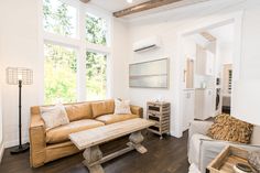 a living room filled with furniture next to a window covered in lots of light shinning