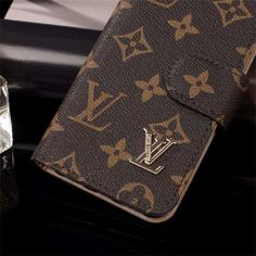 a louis vuitton wallet sitting on top of a table next to an ice cube