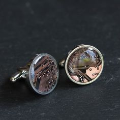 "These cufflinks are made with a unique circuit board pieces in a beautiful black and copper colors. To make our jewelry we use real circuit boards from old computers. The circuit board piece is almost 3/4\" (16 mm) in diameter and is covered with clear resin. Stainless steel cufflinks won't tarnish. High quality guaranteed! You will receive one similar to those you see in pictures, but not the exact one. The colors may vary slightly due to characteristics of the particular board. If you have an Groomsmen Cufflinks, Old Computers, Cufflinks Wedding, Circuit Board, Clear Resin, Clock Face, Copper Color, Gifts For Father, Circuit